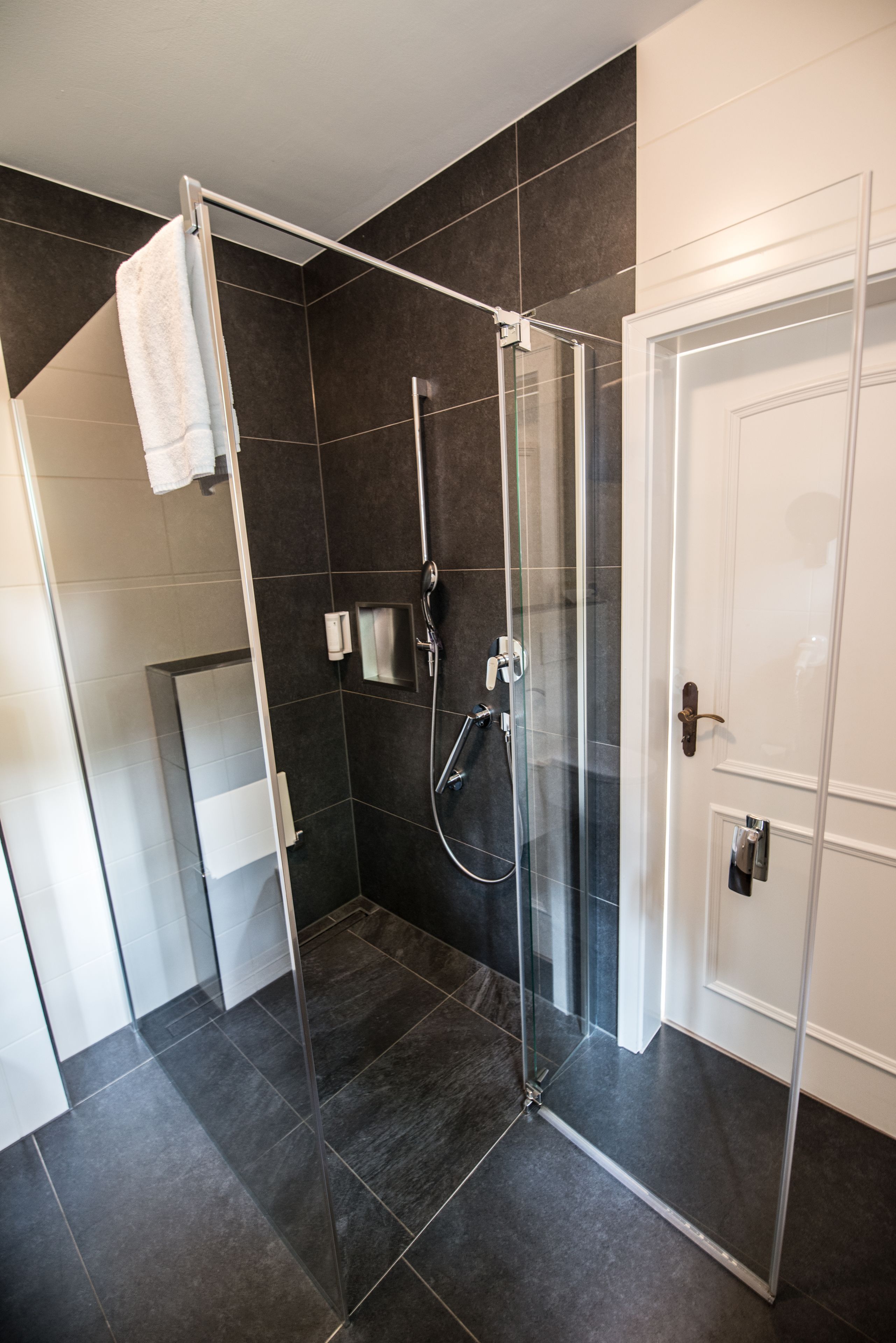 shower, hair dryer, slippers, towels