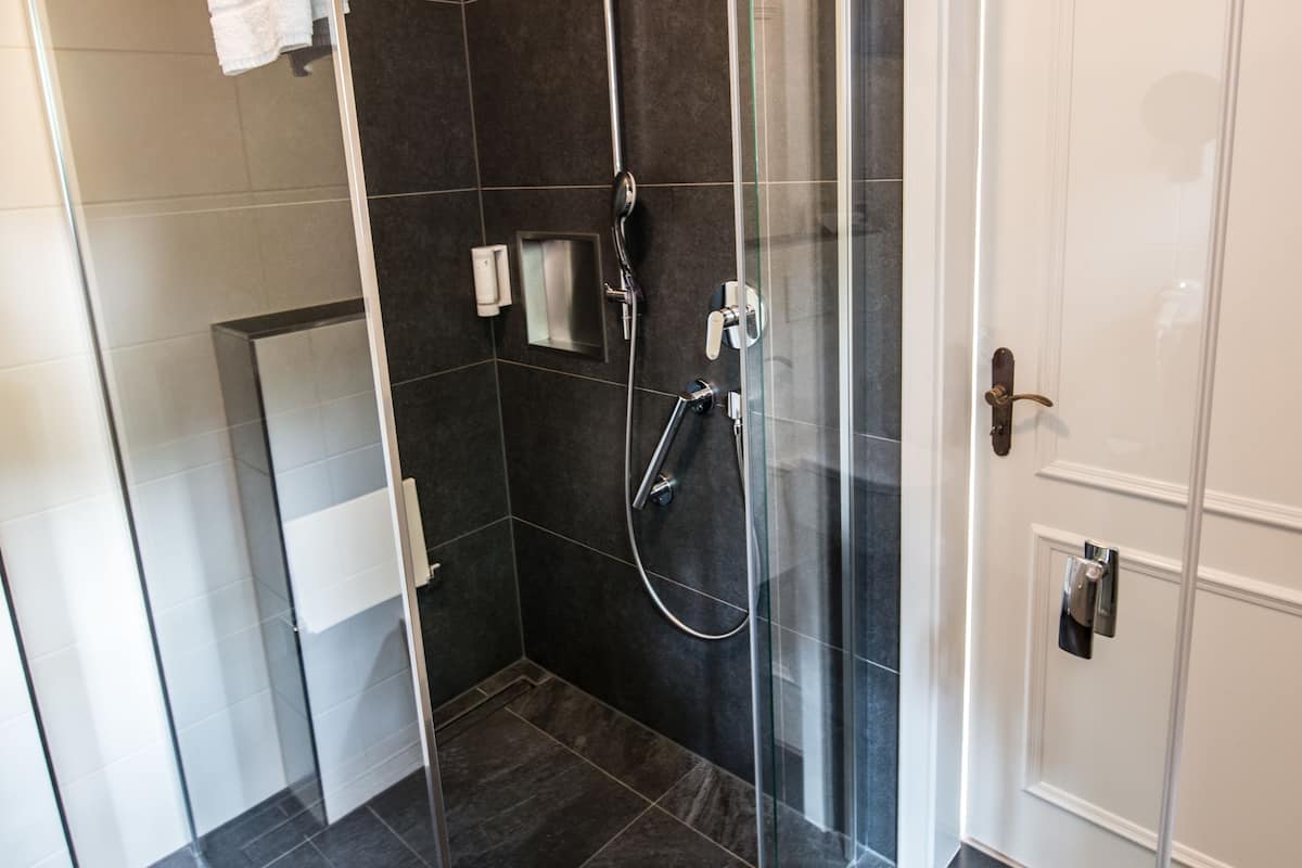 shower, hair dryer, slippers, towels