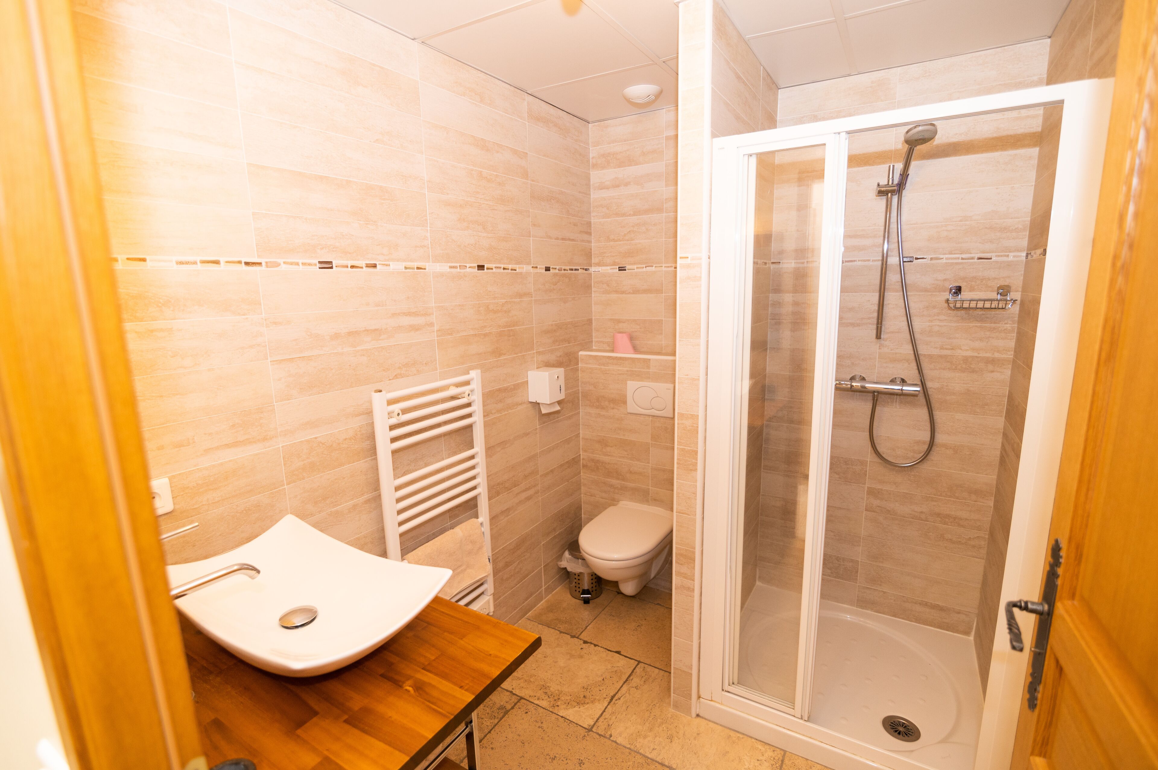 A bathroom with a shower, toilet, and sink.