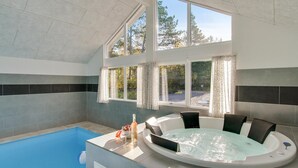 A modern indoor swimming pool with a hot tub, large windows, and a view of trees. - 7 bedroom lovely home in Frederiksværk (Frederiksværk)