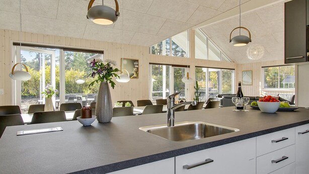 A modern kitchen with a large island, stainless steel sink, and pendant lighting. - 7 bedroom lovely home in Frederiksværk (Frederiksværk)