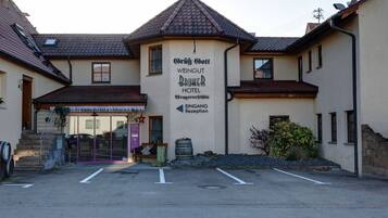 A building with a sign indicating it is the Grift Goff Weingut Brunner Hotel.