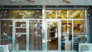 A hotel entrance with glass doors and windows, air conditioning units, and a sign for 'L'Image art hotel'. - L'image Art Hotel (Yerevan)