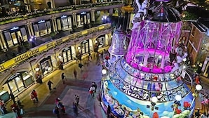 A multi-level atrium with a central fountain, surrounded by shops and restaurants. - Head Sun Guest House (Kowloon)
