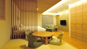 A modern hotel room with a bed, a sofa, a TV, and a wardrobe. - RakutenSTAY×Shamaison Osaka Dekijima Station (Osaka)