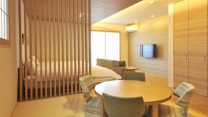 A modern hotel room with a wooden ceiling, a bed, a sofa, a TV mounted on the wall, and a dining area with chairs and a table. - RakutenSTAY×Shamaison Osaka Dekijima Station (Osaka)