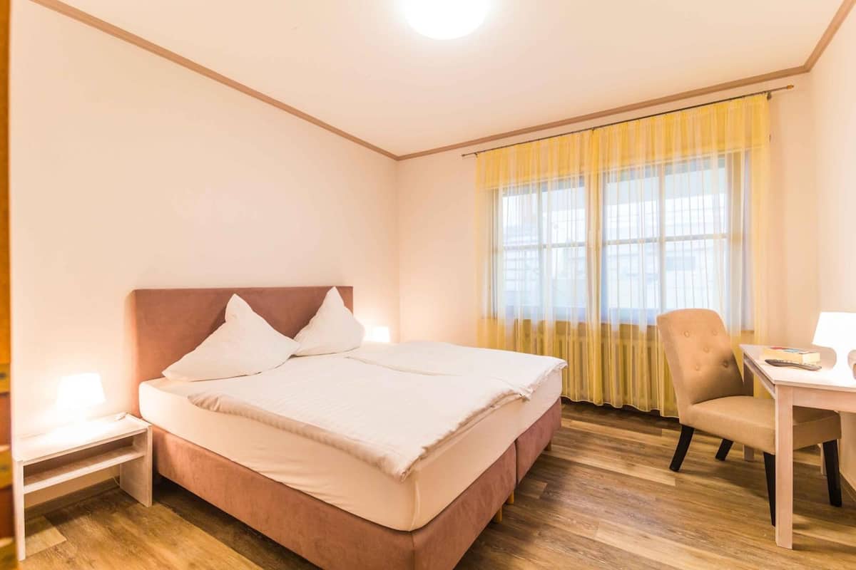 desk, laptop workspace, blackout curtains, cots/infant beds