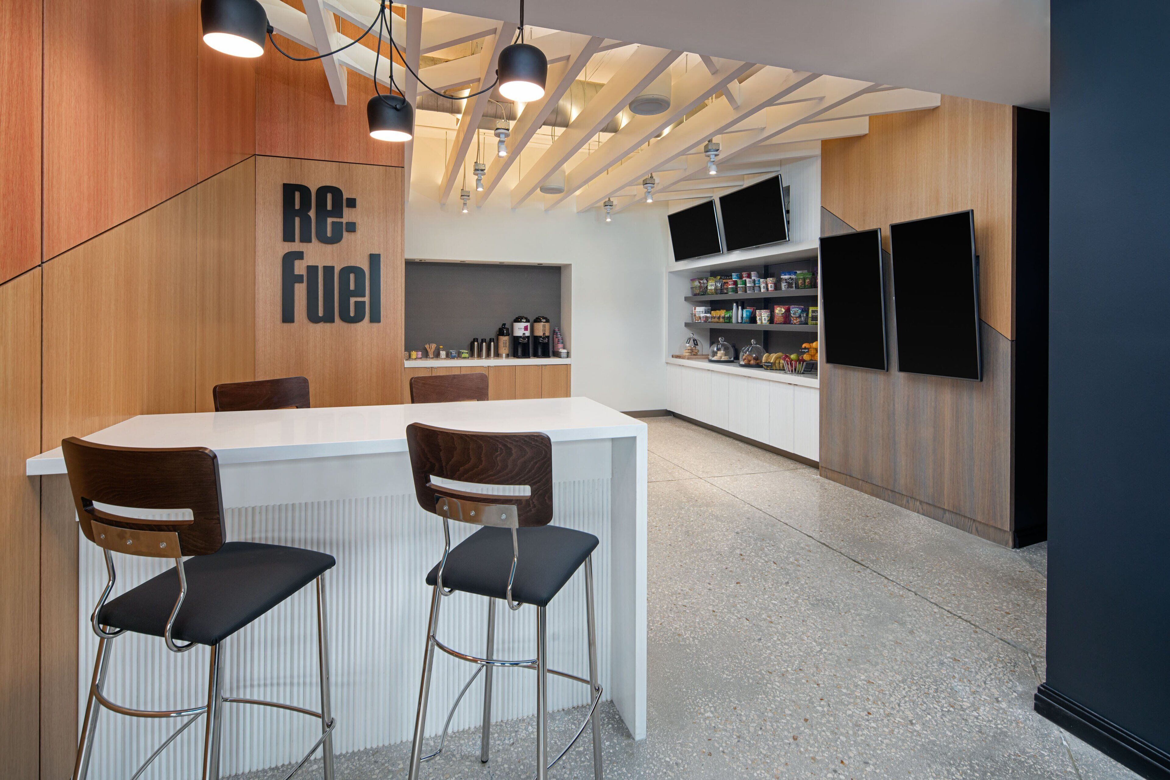 A modern kitchen with a bar area, wooden accents, and built-in appliances.