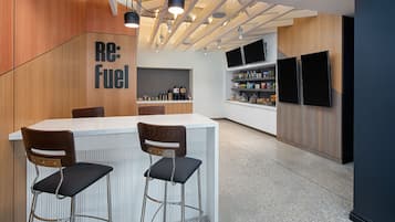 A modern kitchen with a bar area, wooden accents, and built-in appliances.