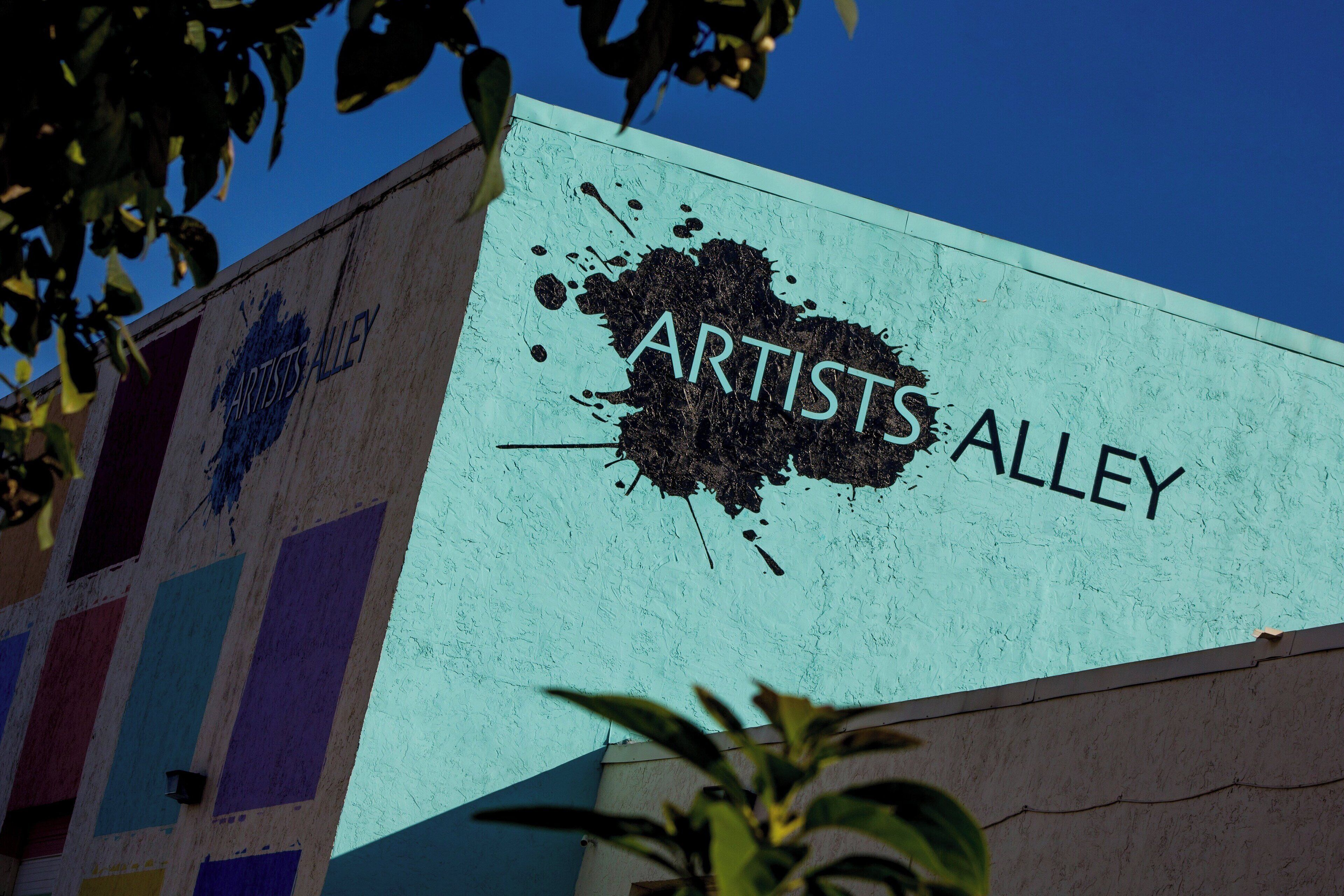 A building with a sign that reads "Artists Alley."