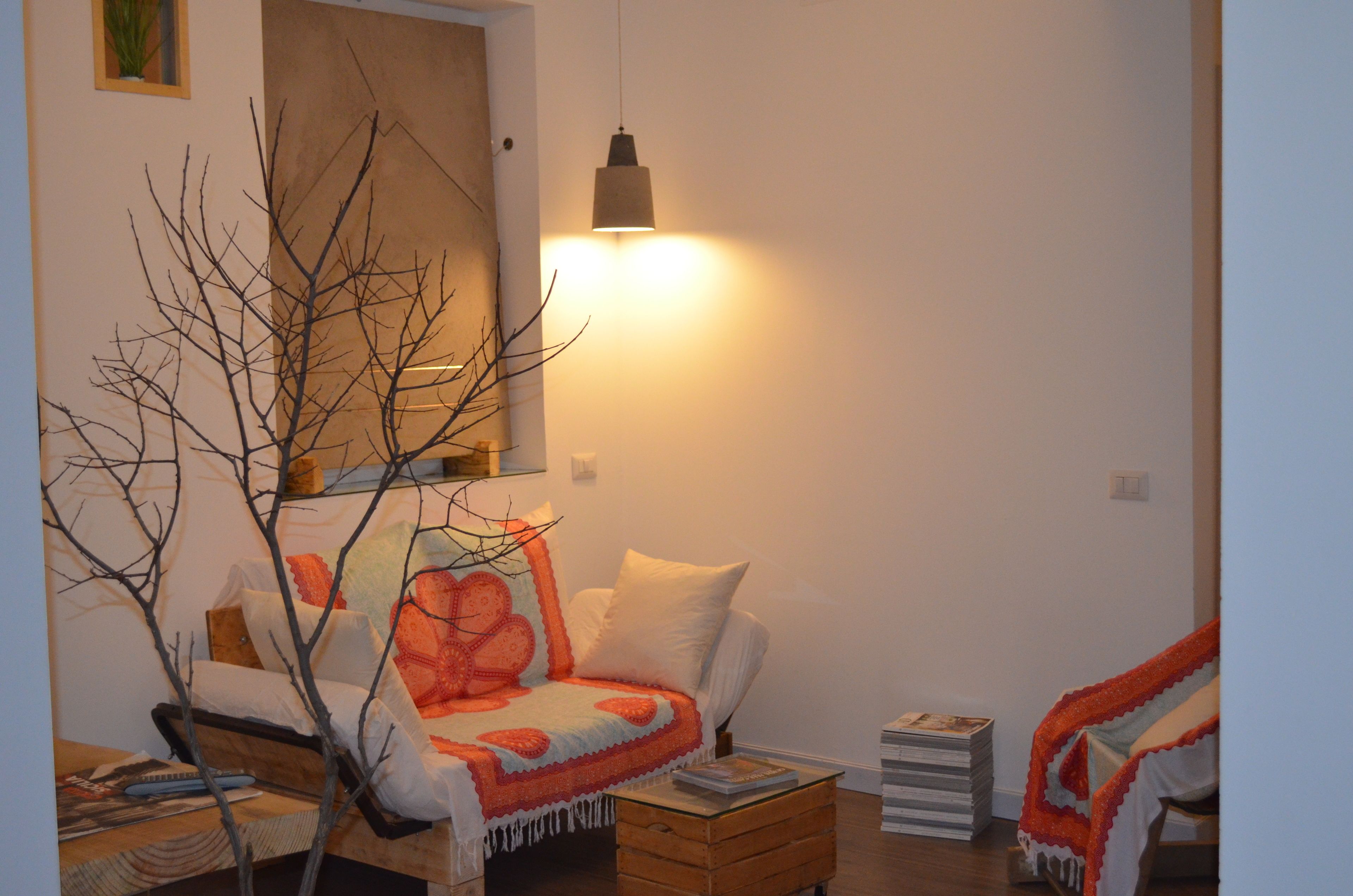 A cozy living room with a sofa, a coffee table, and a bookshelf.