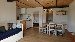 A cozy kitchen with a dining area, wooden floors, and a built-in bench. - Aagaarden (Billund)