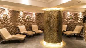 A spa area with stone walls, a central pillar, and several lounge chairs. - Mirart Hotel Boutique & SPA Yalova (Yalova)