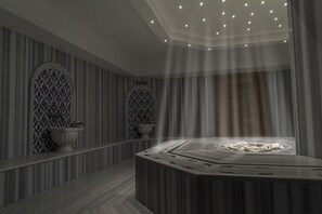 A modern spa room with a central hot tub, striped walls, and decorative tiles. - Mirart Hotel Boutique & SPA Yalova (Yalova)