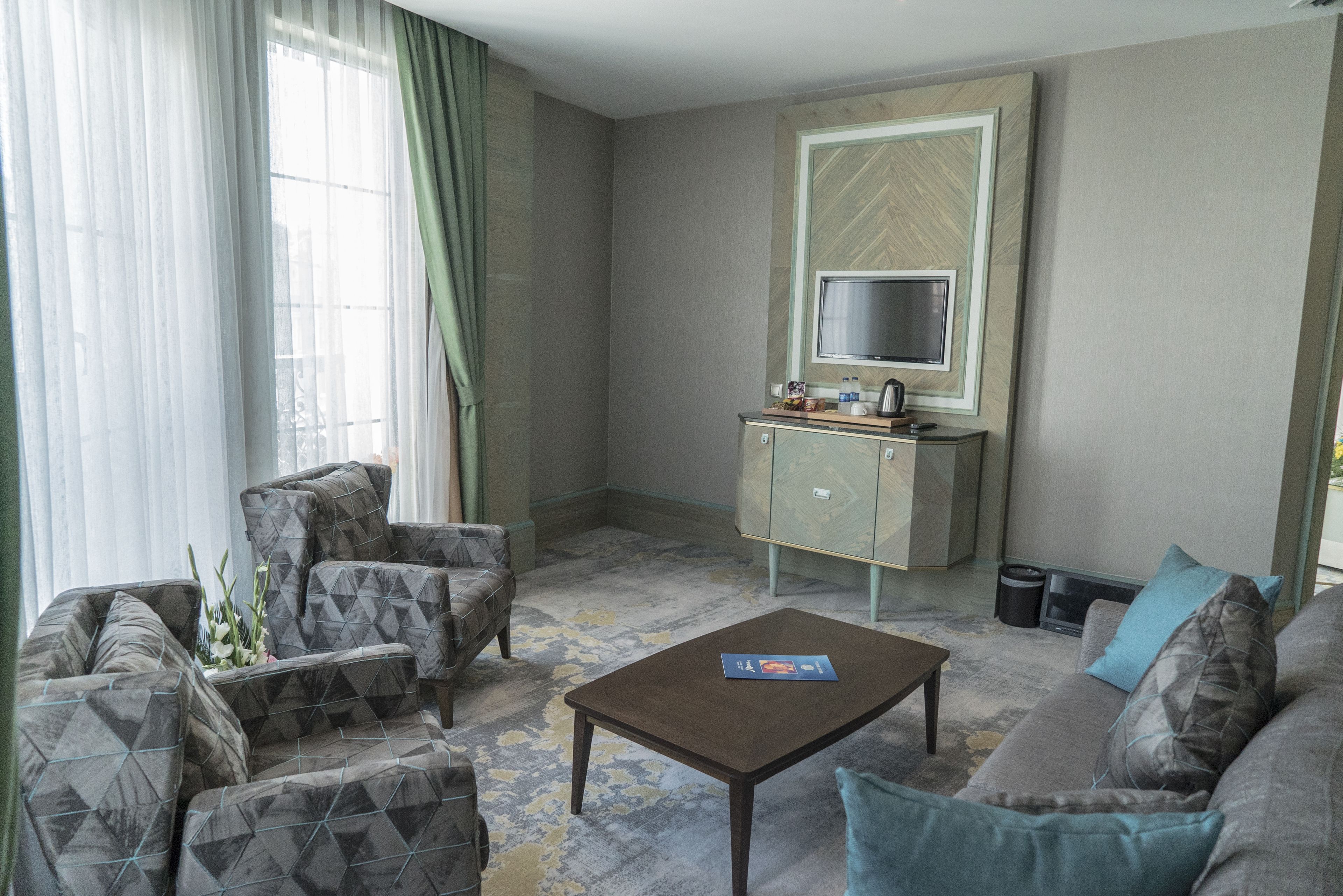 family suite, multiple beds | living room | lcd tv