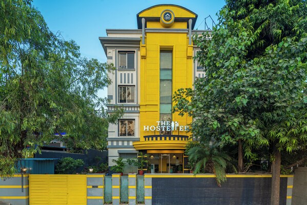 A yellow building with a sign reading "The Hosteller." - The Hosteller Delhi (New Delhi)