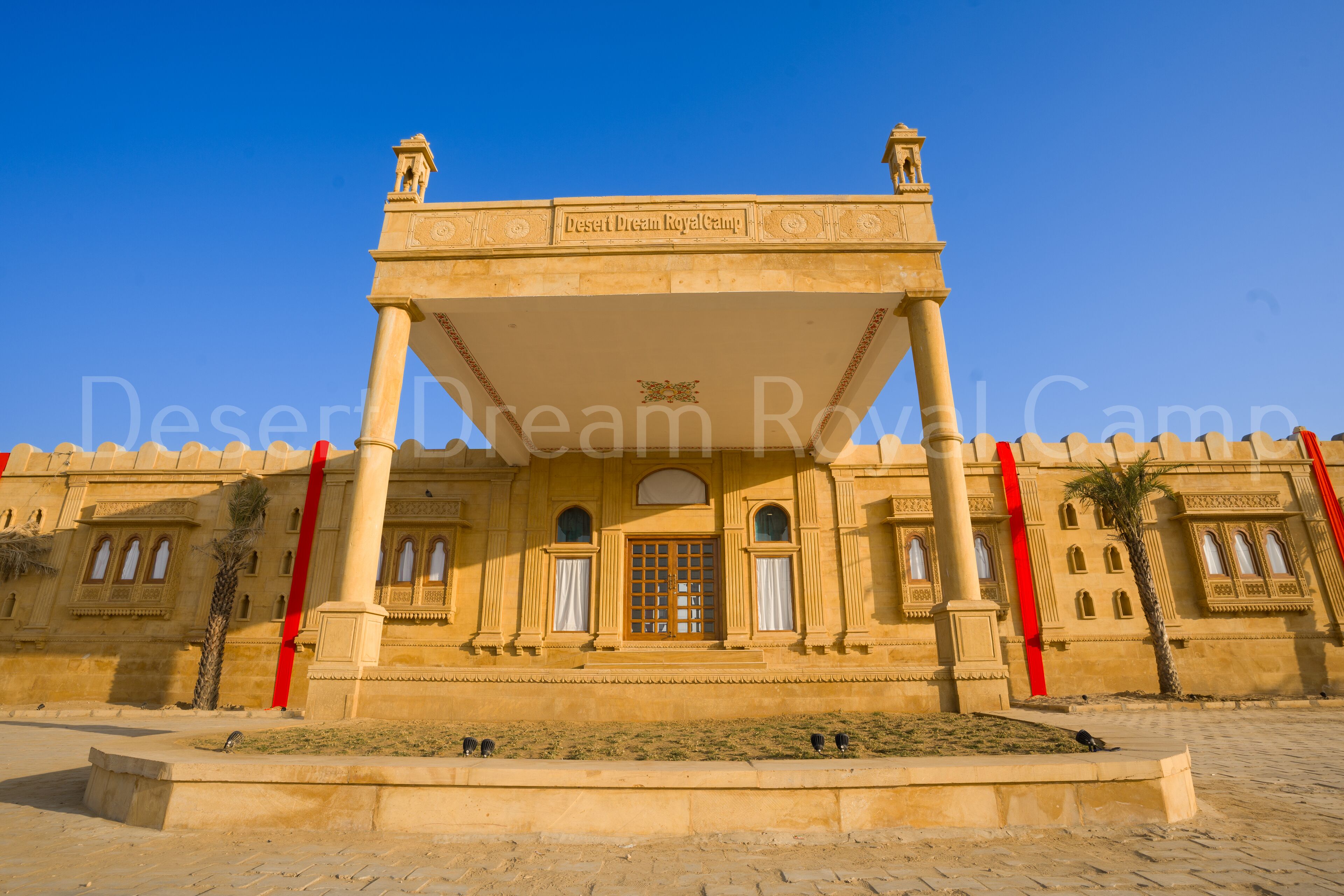 A grand entrance with a sign reading "Desert Dream Royal Camp."