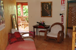 Relax in a comfortable seating area with a sofa and two chairs, surrounded by a simple, clean design.