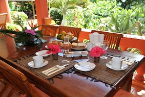 Enjoy a meal surrounded by lush greenery at this outdoor dining setting.