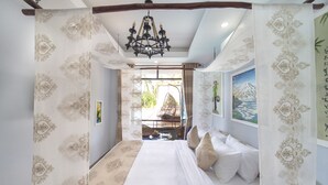 A bedroom with a large bed, a chandelier, and a view of the outdoors. - VIP Garden Villa and Pool (Da Nang)