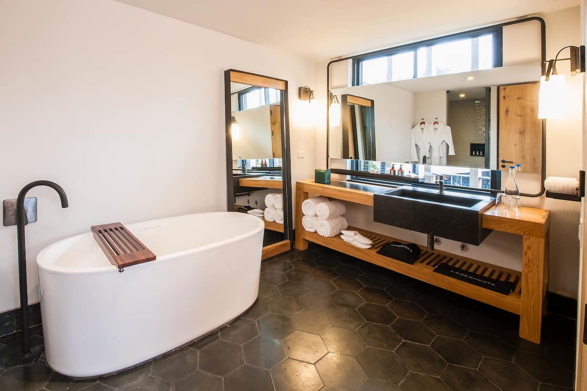 superior suite, 1 king bed, private bathroom, tower | bathroom | hair dryer, bathrobes, towels, soap