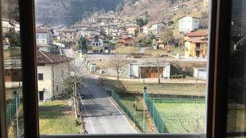 A residential area with houses, a road, and a green field.