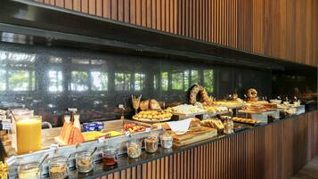 A buffet with various food items and condiments.