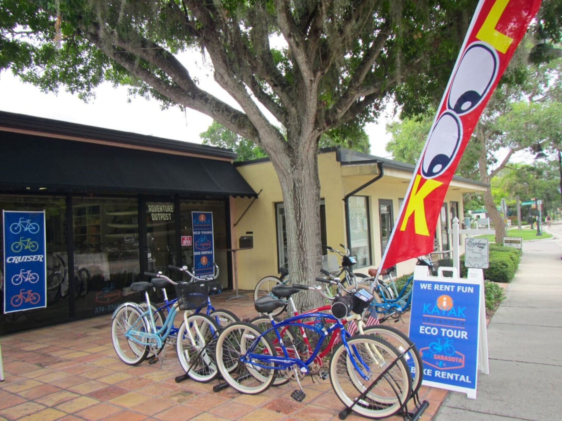 A bicycle rental shop with a sign for eco tours and kayak rentals.