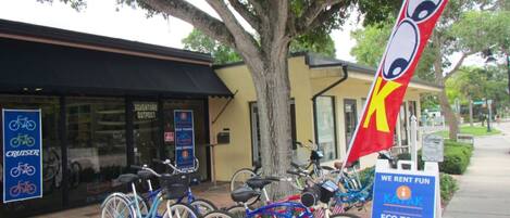 A bicycle rental shop with a sign for eco tours and kayak rentals.