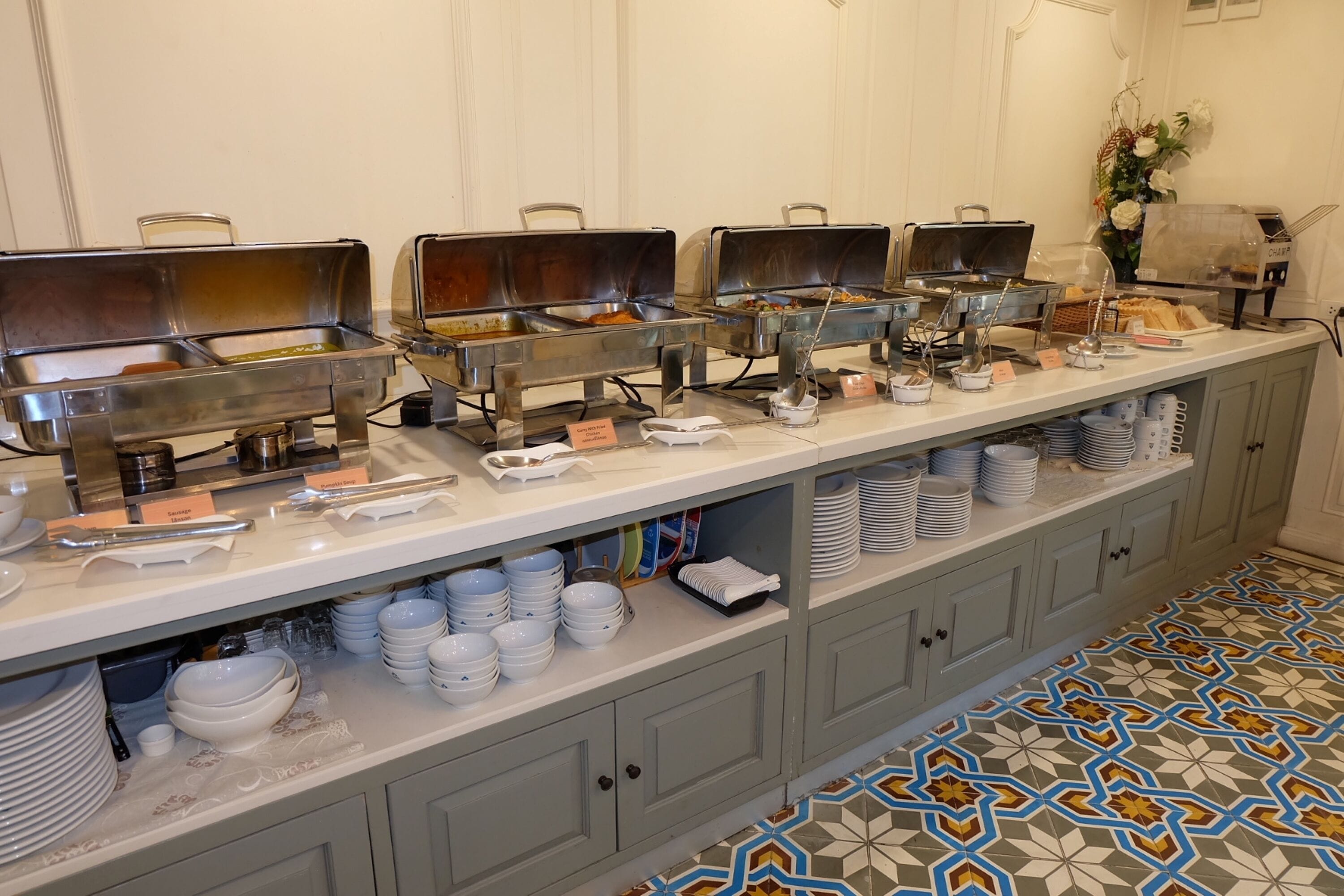 A buffet setup with multiple food stations, a variety of dishes, and neatly arranged serving dishes.