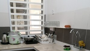 A kitchen with a sink, a stove, and a window with blinds. - Goodlife Paradise Cameron Jaya (Tanah Rata)