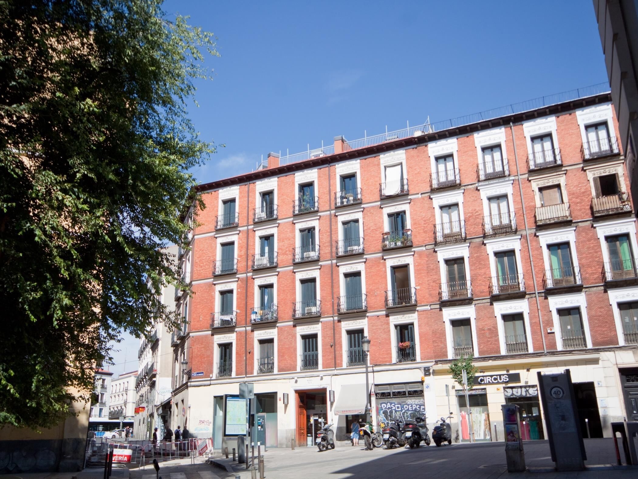 A multi-story building with a consistent architectural style, featuring evenly spaced windows and balconies.