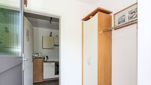 A compact kitchen with white cabinets, a wooden countertop, and a small coffee maker. - Nice apartment for 4 guests with WIFI, TV and patio (Helfenstein)