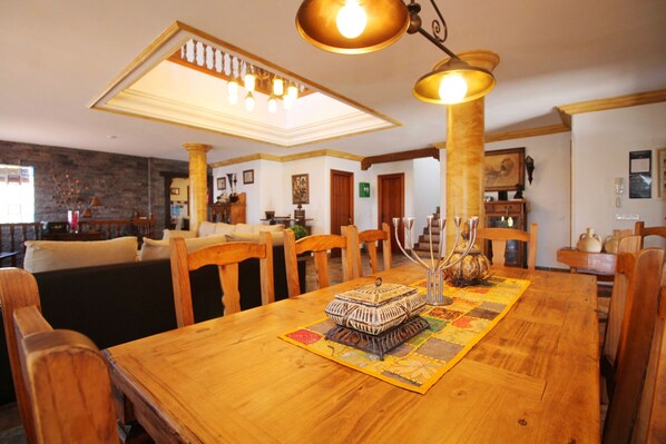 A dining area with a wooden table, chairs, and a central decorative piece.