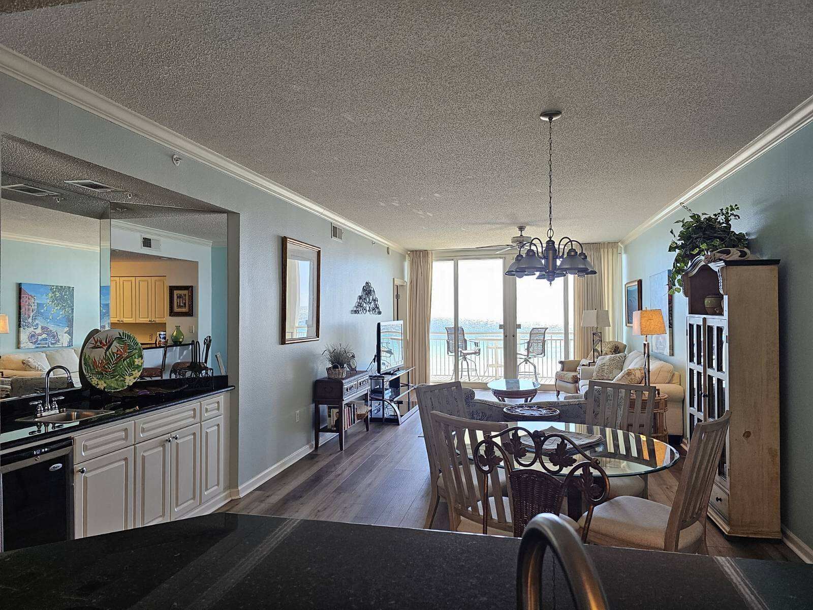 A spacious living area with a dining table, comfortable seating, and a view of the outdoors.
