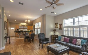 Relax in a spacious living area with a large window, comfortable sofa, and dining space.