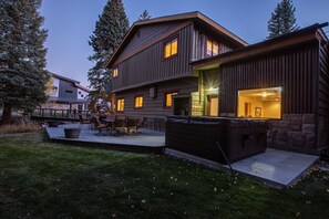 Large back deck with plenty of outdoor seating and extra-large hot tub