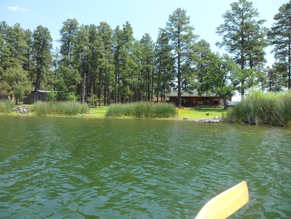 Situated lakeside, this lodge offers a serene escape with a welcoming porch and natural surroundings.
