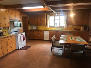 Enjoy cooking in this well-equipped kitchen with appliances, a central island, and a dining area.