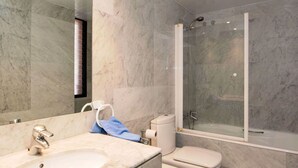 A bathroom with a marble sink, toilet, and a glass-enclosed shower. - Nice apartment for 3 people with WIFI, A/C and TV (Barcelona)