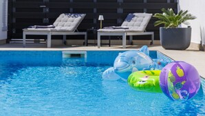 A swimming pool with lounge chairs and inflatable toys. - Beautiful  villa for 6 guests with WIFI, A/C, private pool, TV, terrace and panoramic view (Pazin)