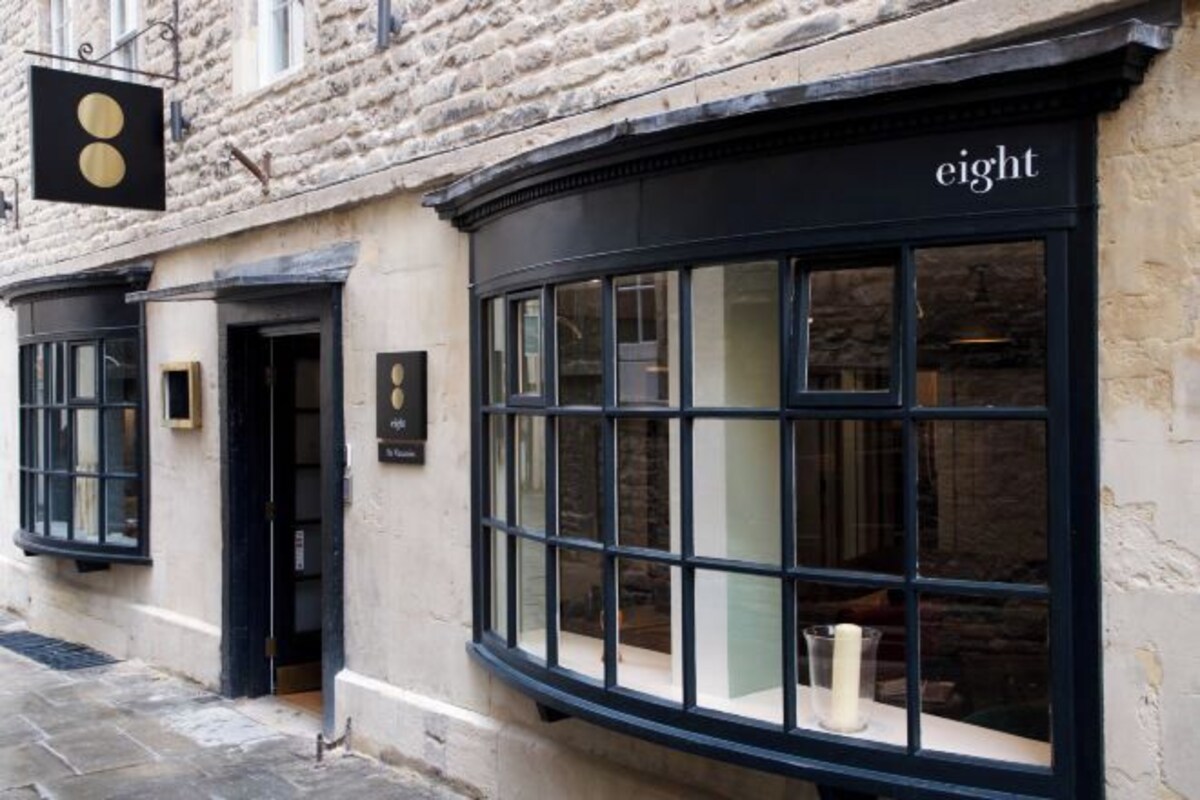 A building with a black awning and a sign that reads "eight".