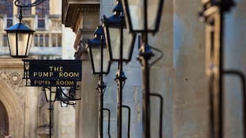 A street lamp and a sign reading "The Pump Room" attached to a building.