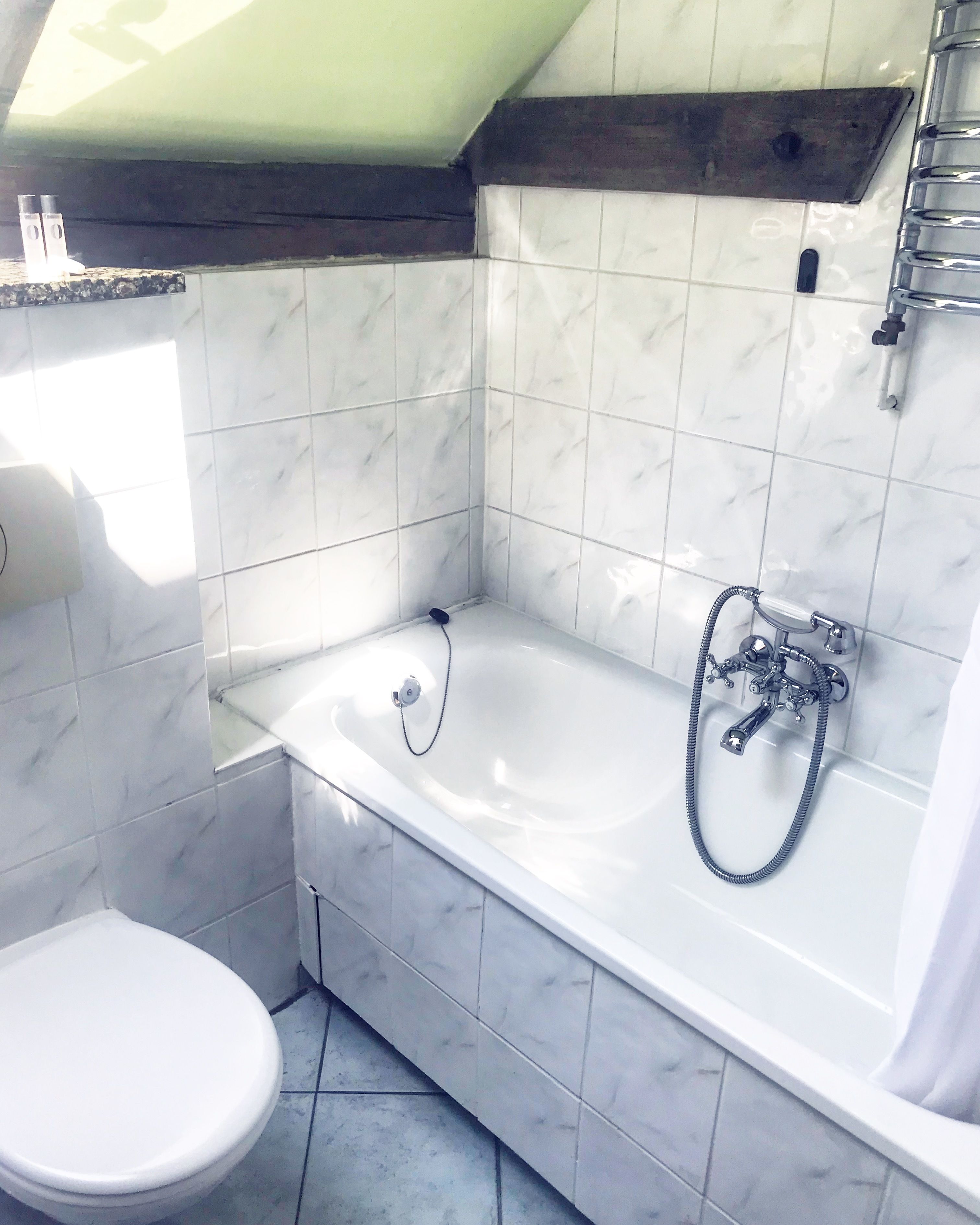 A bathroom with a bathtub, toilet, and a shower.