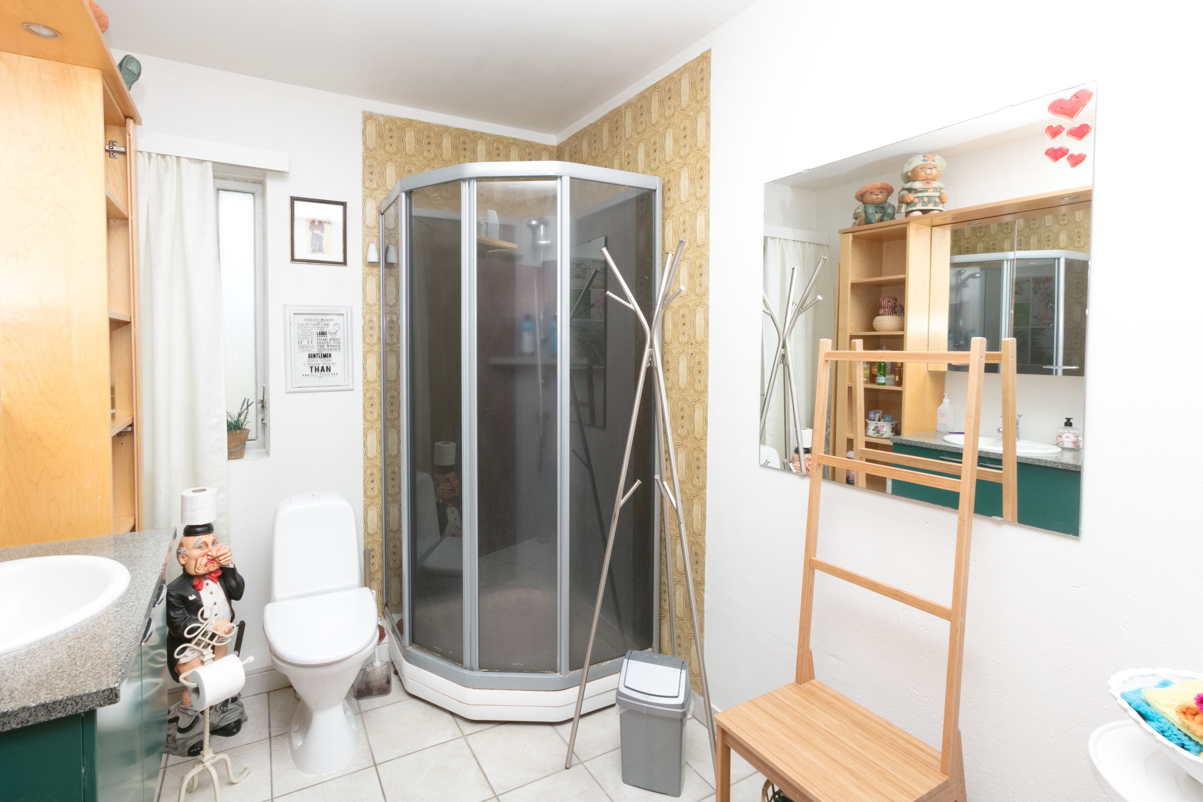 A bathroom with a shower, toilet, and sink.
