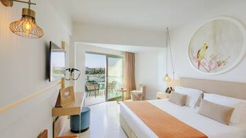 A hotel room with a bed, a desk, a chair, a balcony with a view, and a painting on the wall.