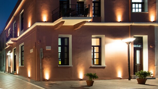 A multi-story building with a flat roof, large windows, and a balcony. - Intra Muros Hostel (Heraklion)