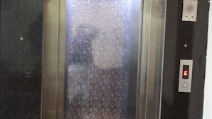 An elevator with a patterned glass door, a digital display, and a control panel. - Hotel Ivory Palace (New Delhi)