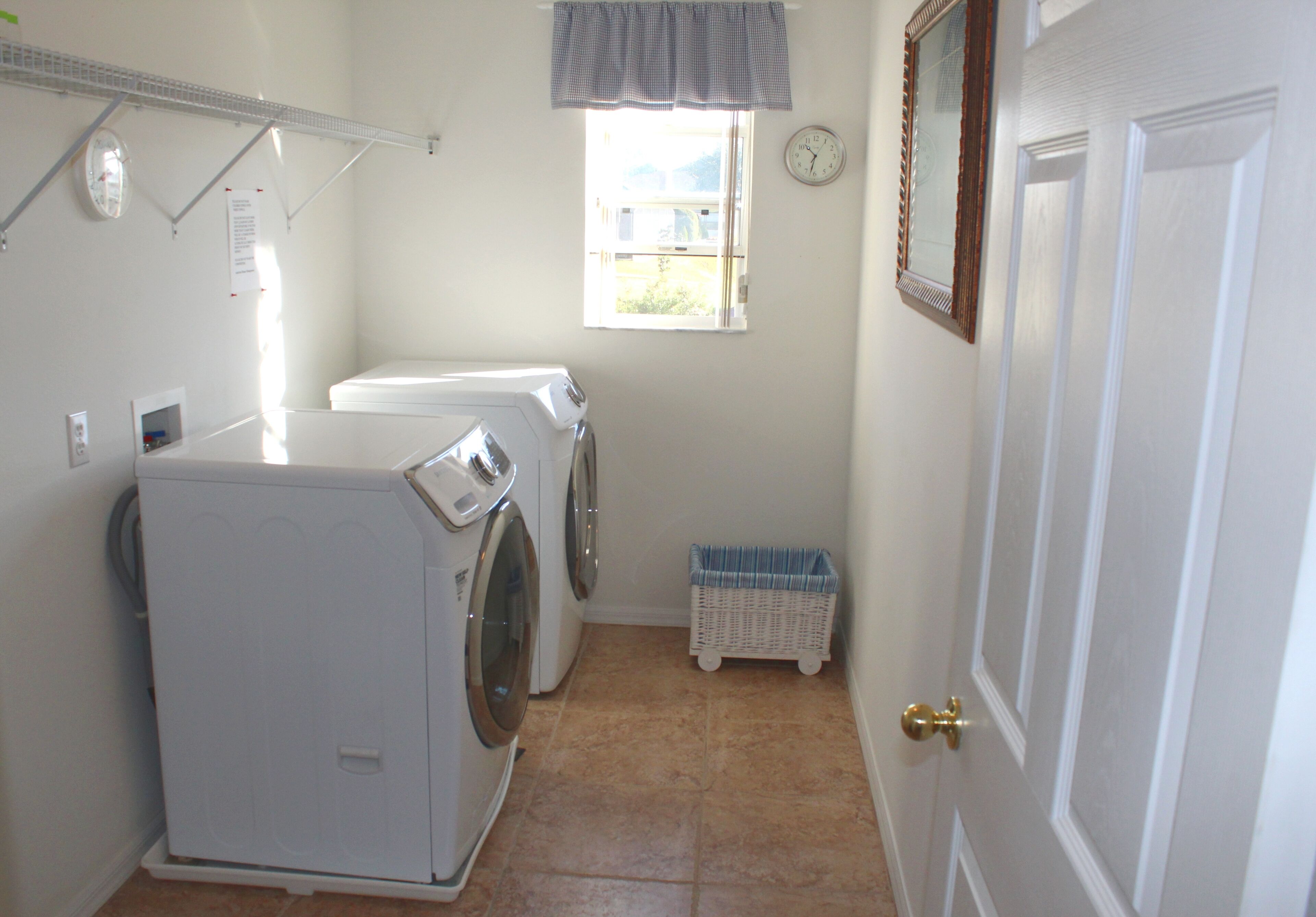 2nd floor Laundry room w/ large capacity front loading washer/dryer, iron board.