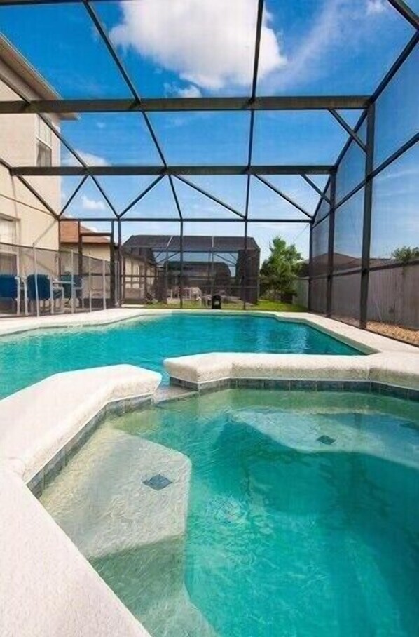 Relax by the pool under a transparent roof, surrounded by a concrete deck.